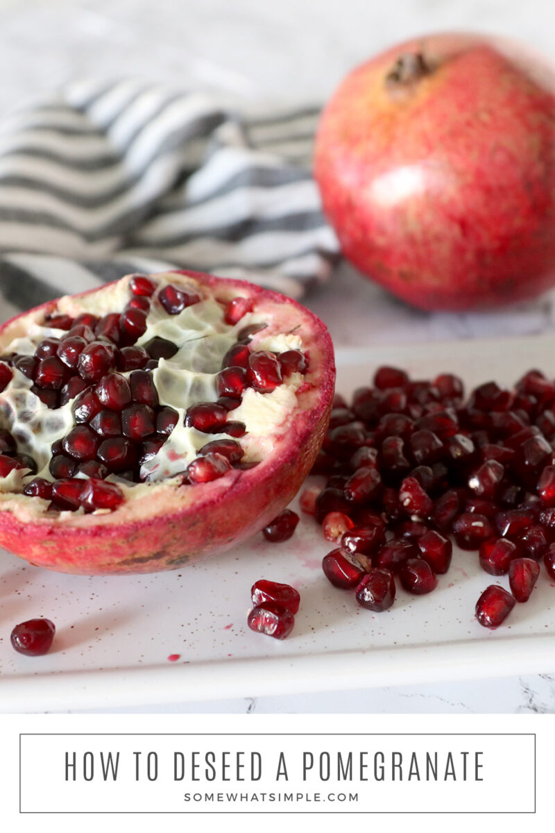 long image of a cut pomegranate on a counter