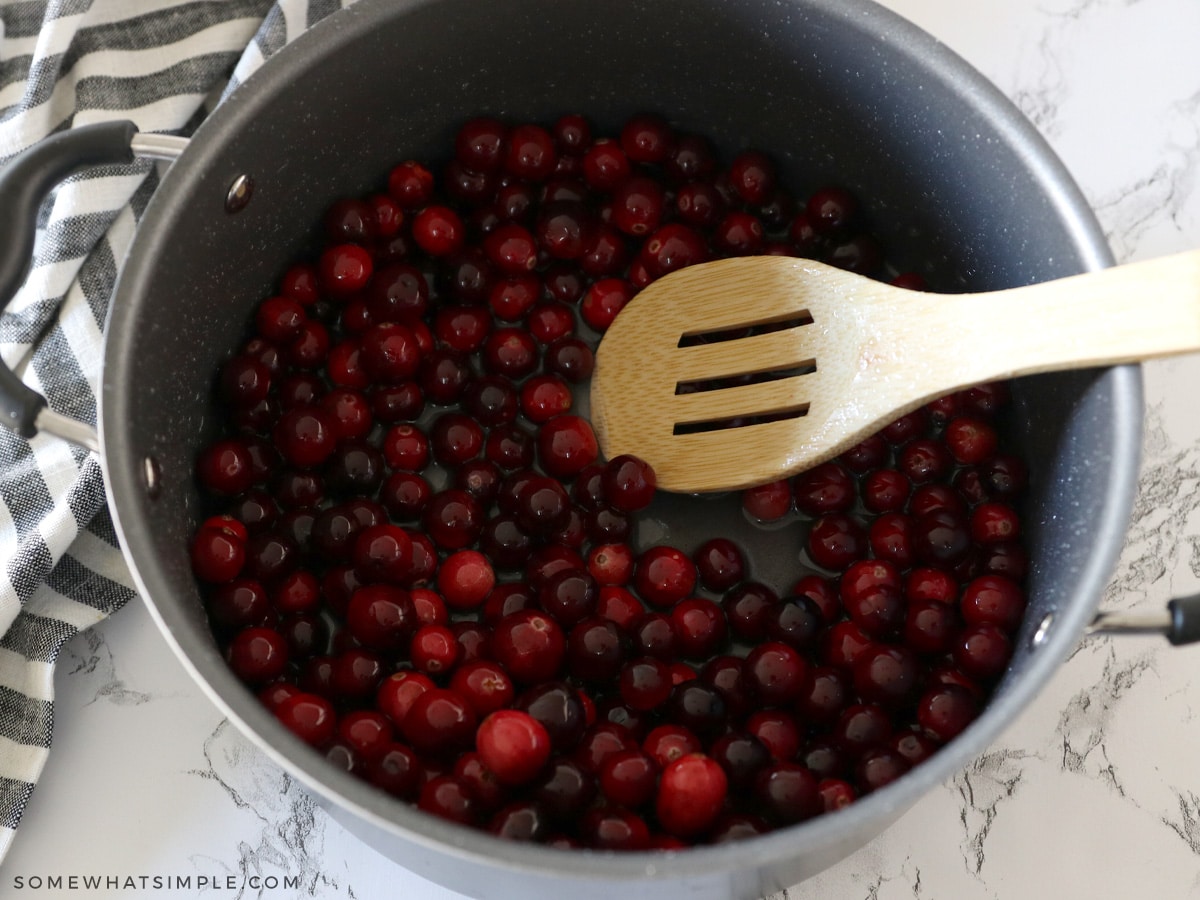 cranberries in a medium saucepan covered with a simple syrup