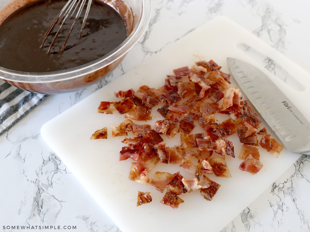 chopped bacon with brownie batter in the background