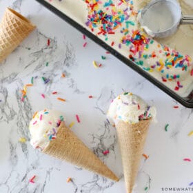 birthday cake ice cream in cones on a counter