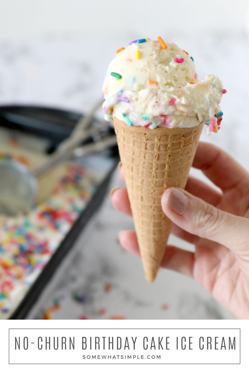 long image of a hand holding a cone with a scoop of ice cream