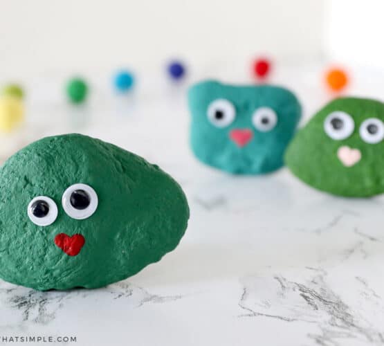 green rock painted green with googly eyes and a heart mouth - a blarney stone craft for kids