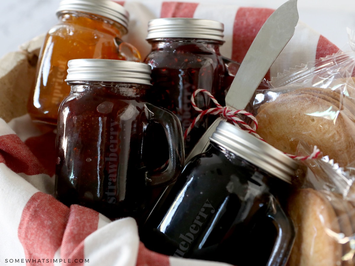 basket of glass jelly jars with some cookies