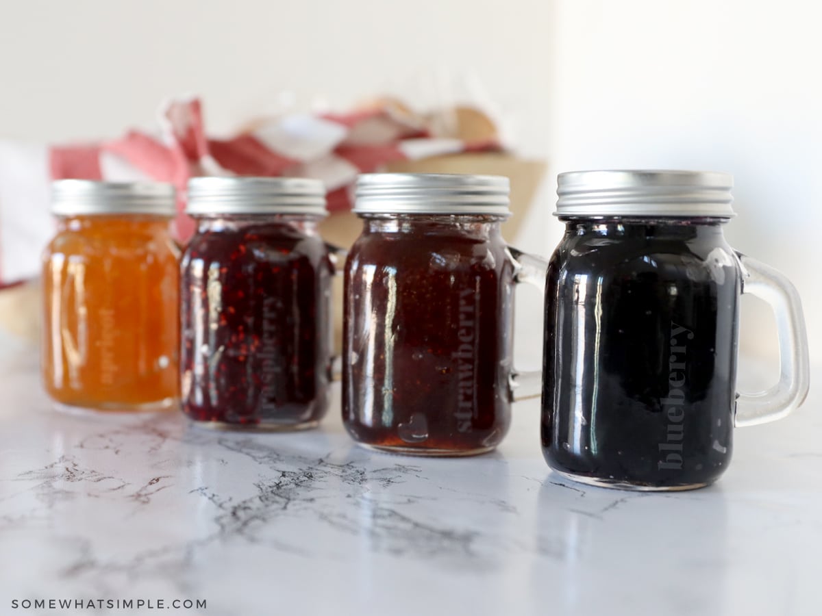 4 glass jelly jars in a line