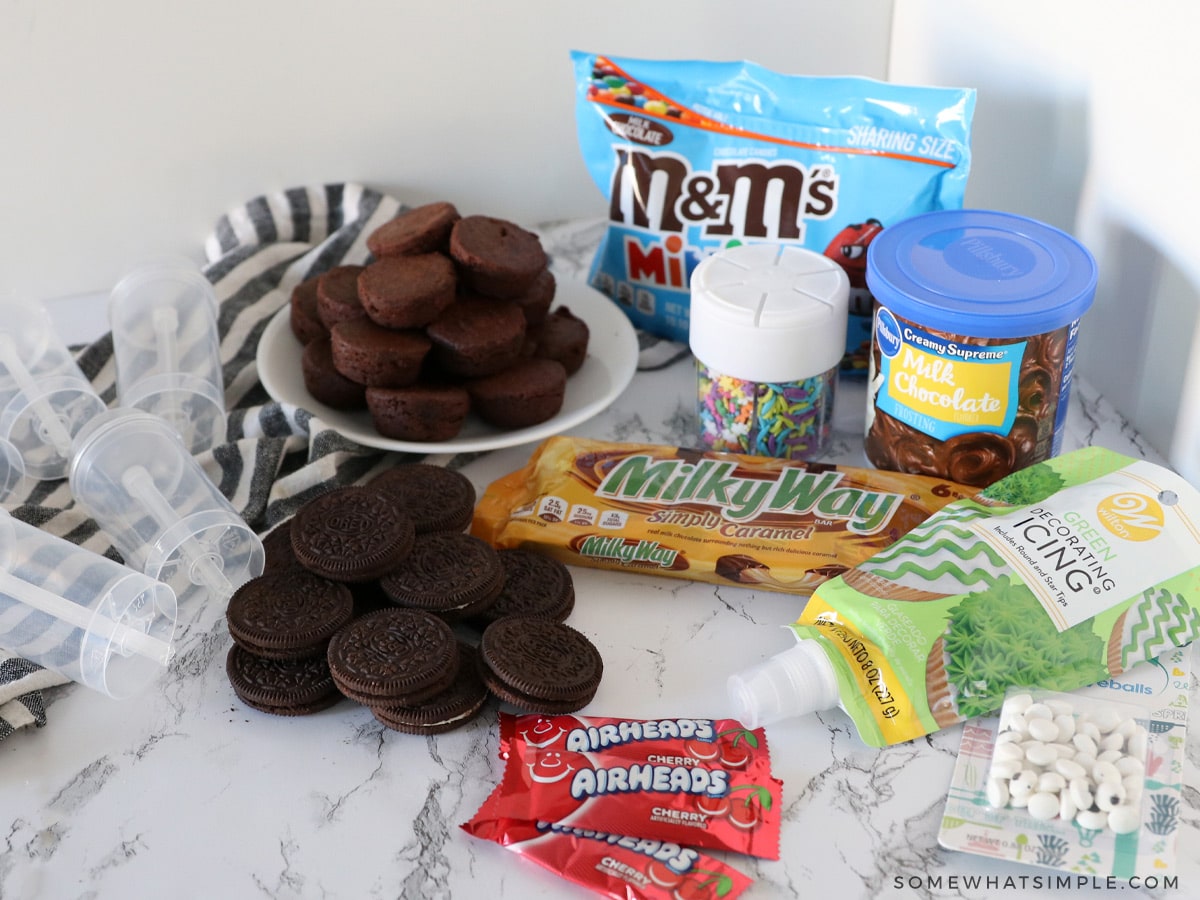 ingredients for making push pop cake pops on a white counter