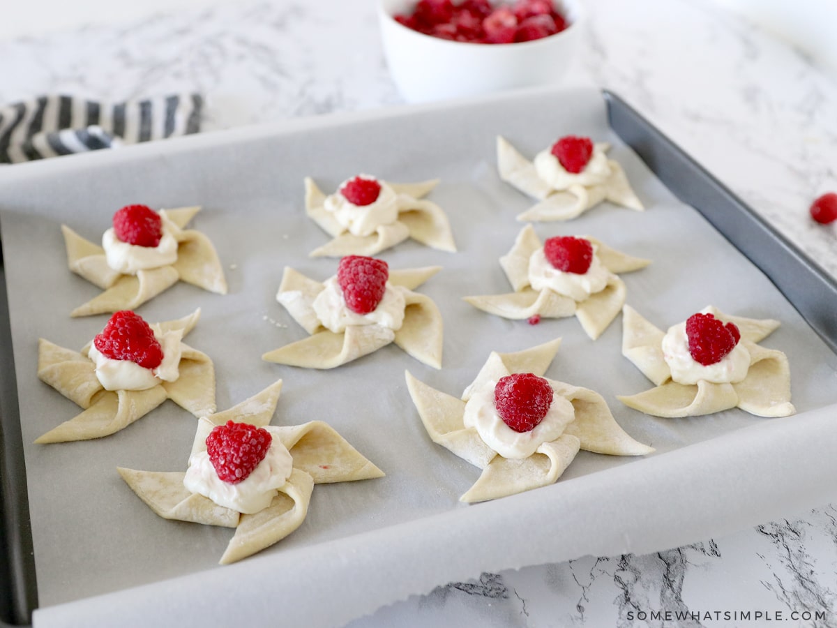 filling puff pastry with cream cheese and raspberries