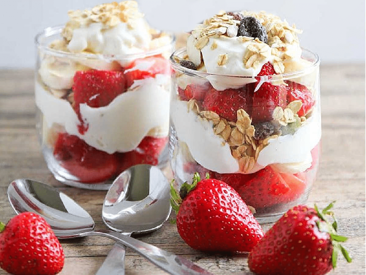two berry parfaits made with yogurt, granola, and fresh berries