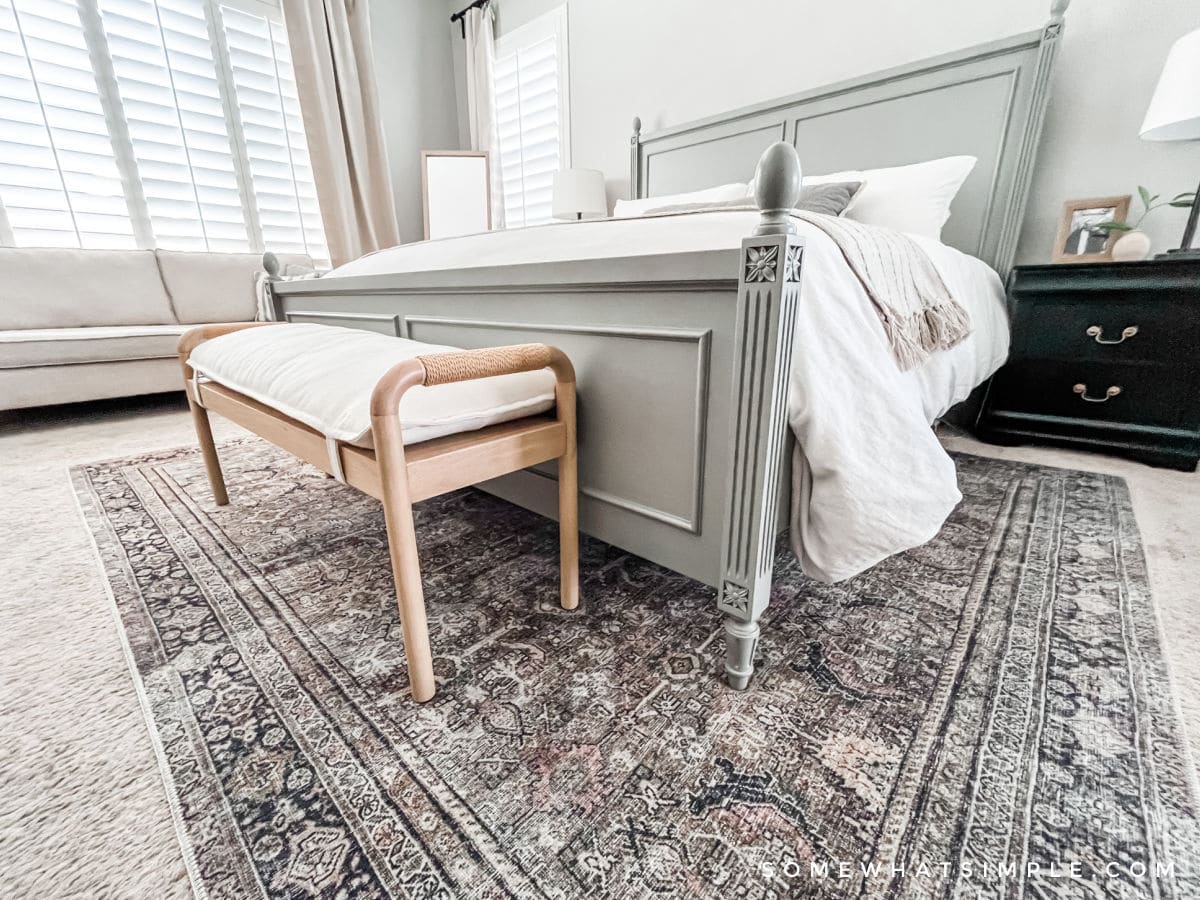 colorful rug under a bed in a primary bedroom