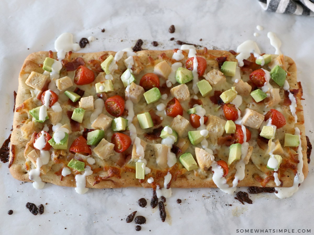 adding avocado and ranch to a chicken flatbread