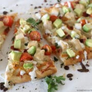 california chicken flatbread sliced in triangles on the counter