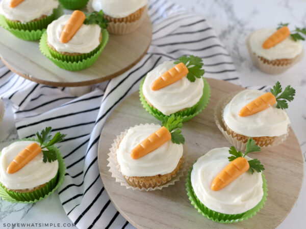 several carrot cake cupcakes laid out on a counter