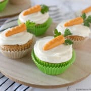 carrot cake cupcakes on a wood platter