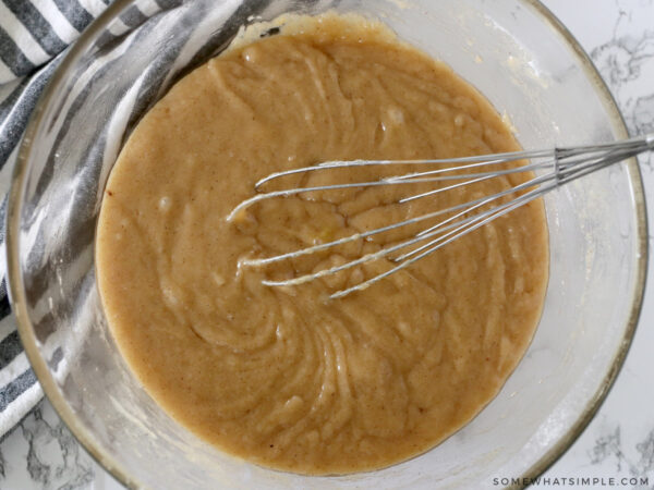 mixing cupcake batter in a glass bowl