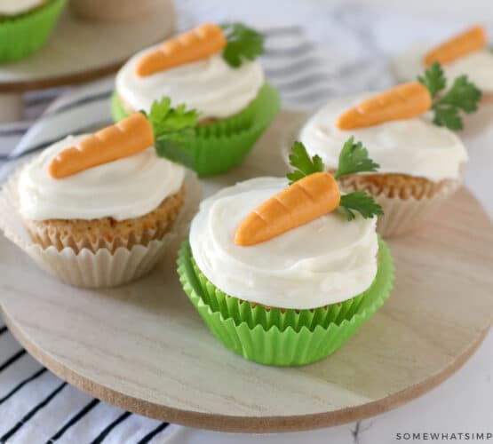 carrot cake cupcakes on a wood platter