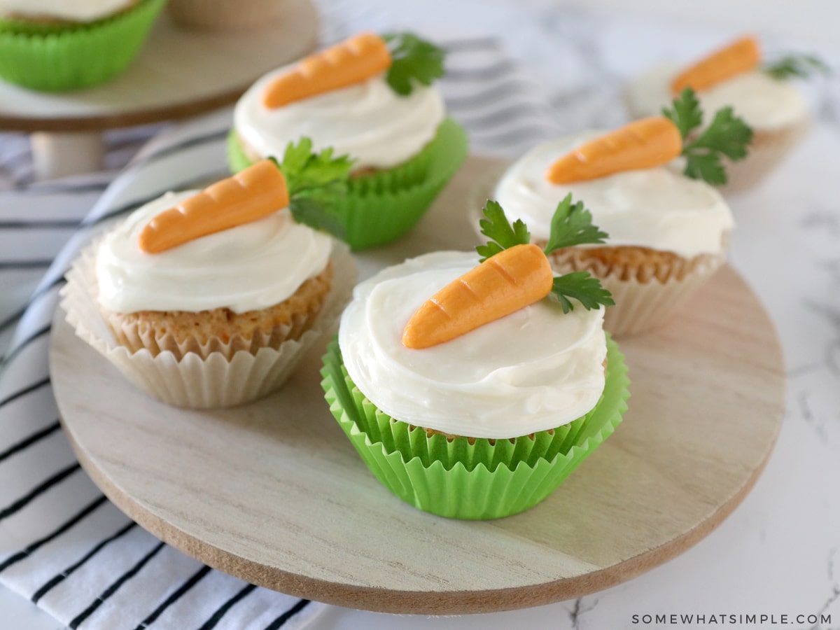 carrot cake cupcakes on a wood platter