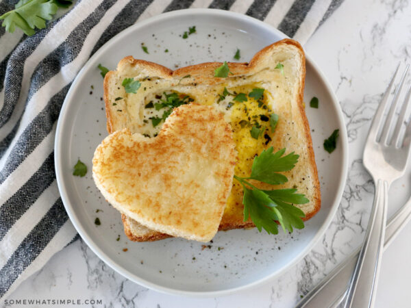 heart shaped eggs in toast plated on a white plate
