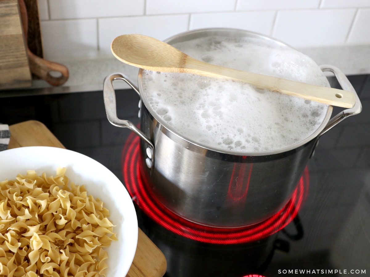 wooden spoon laying over a pot of boiling water