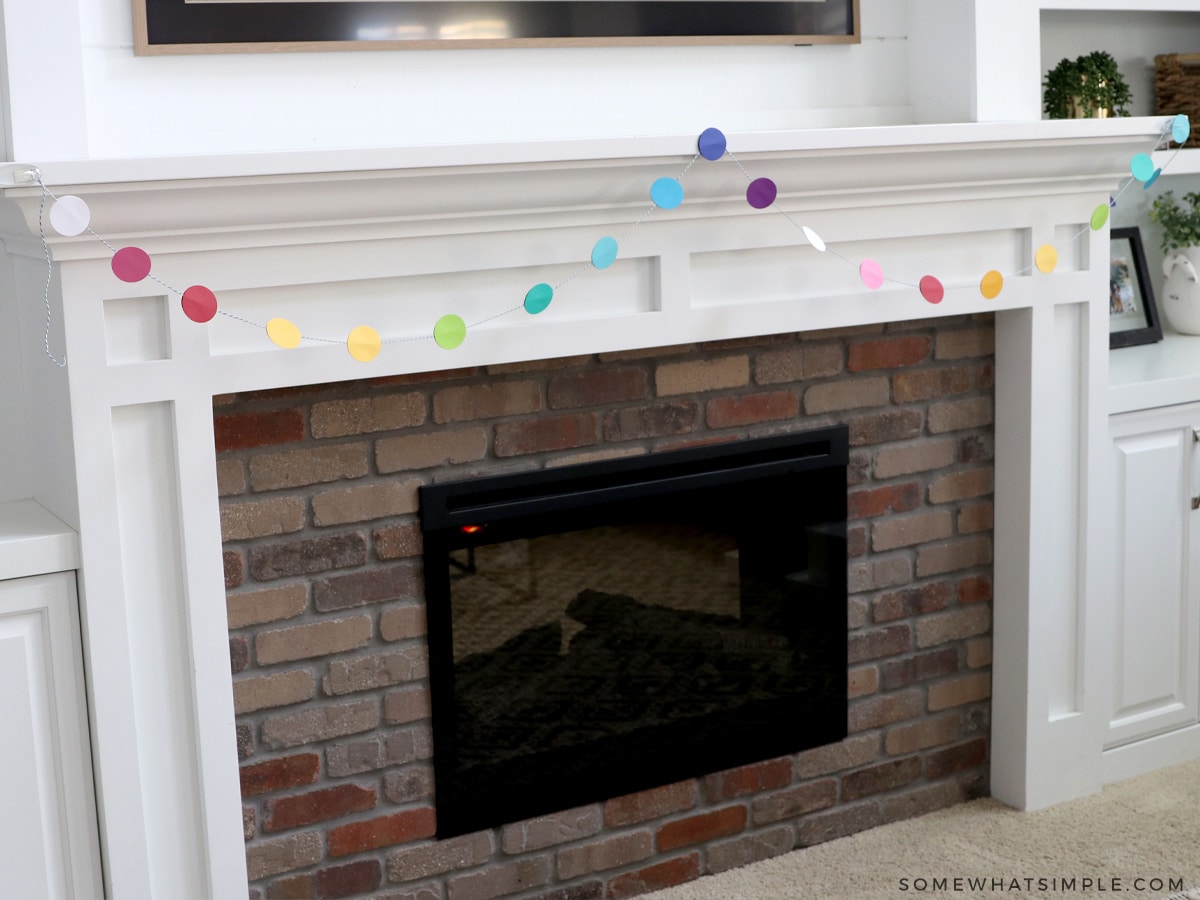 paper cirle garland hanging on the fireplace
