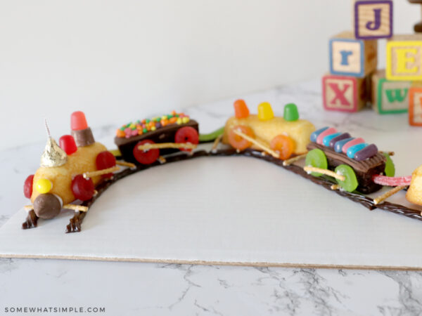 train cake on a white counter next to building blocks