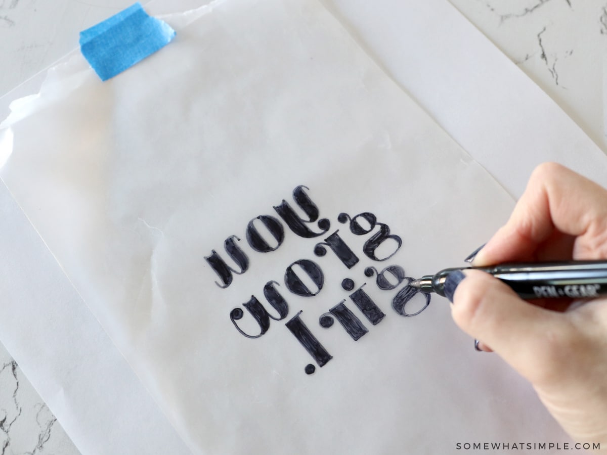 using a marker and tracing a quote onto wax paper