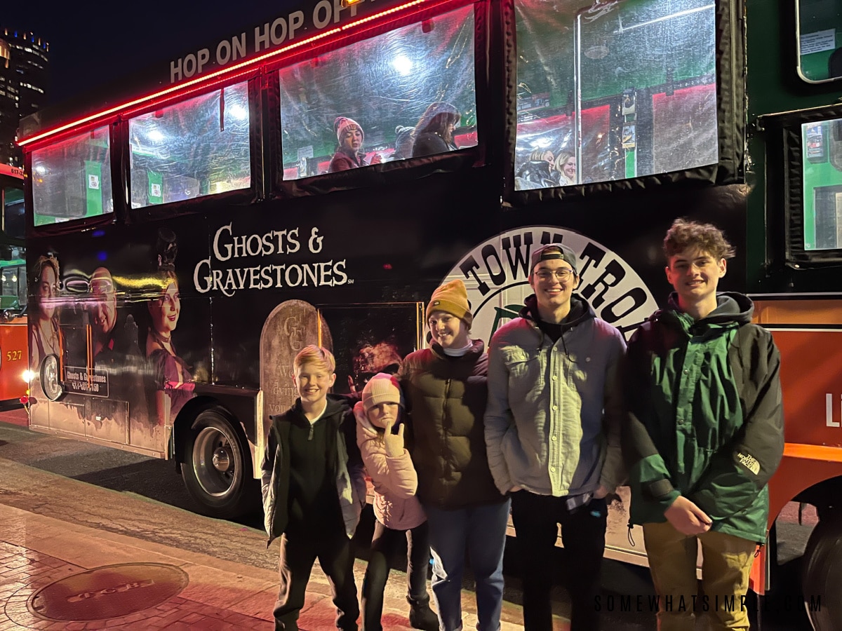 kids standing in front of a trolley before a ghost tour in boston