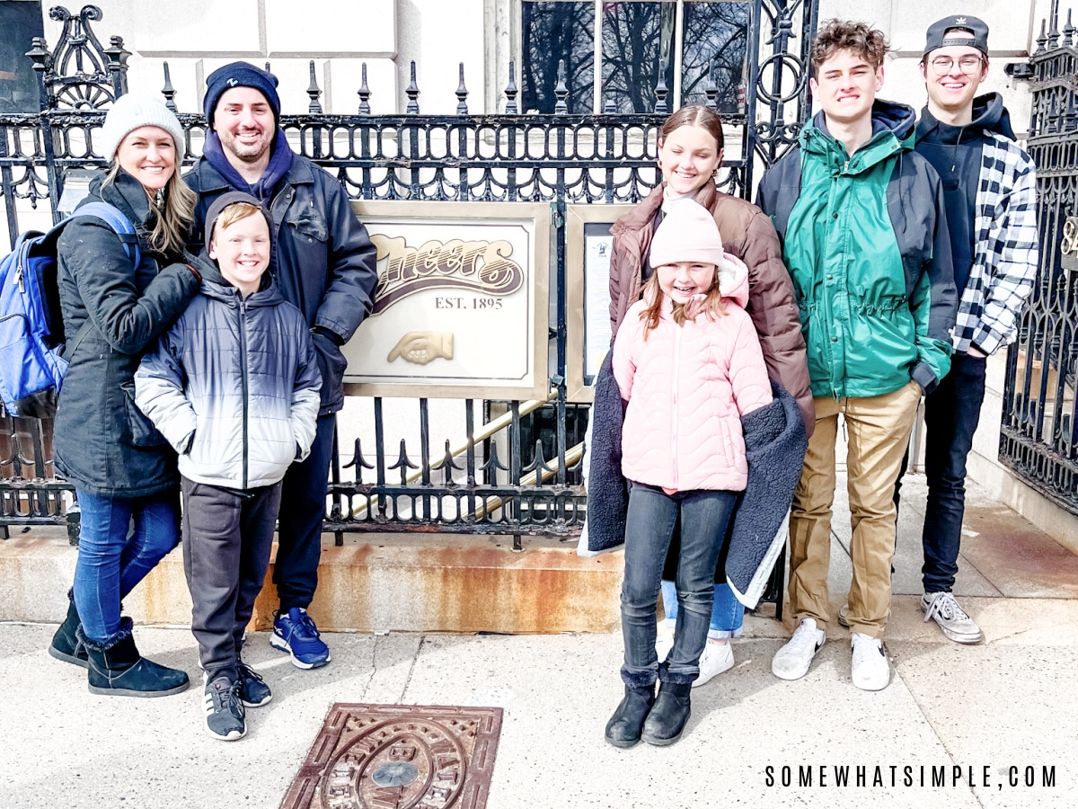 family standing outside the cheers bar