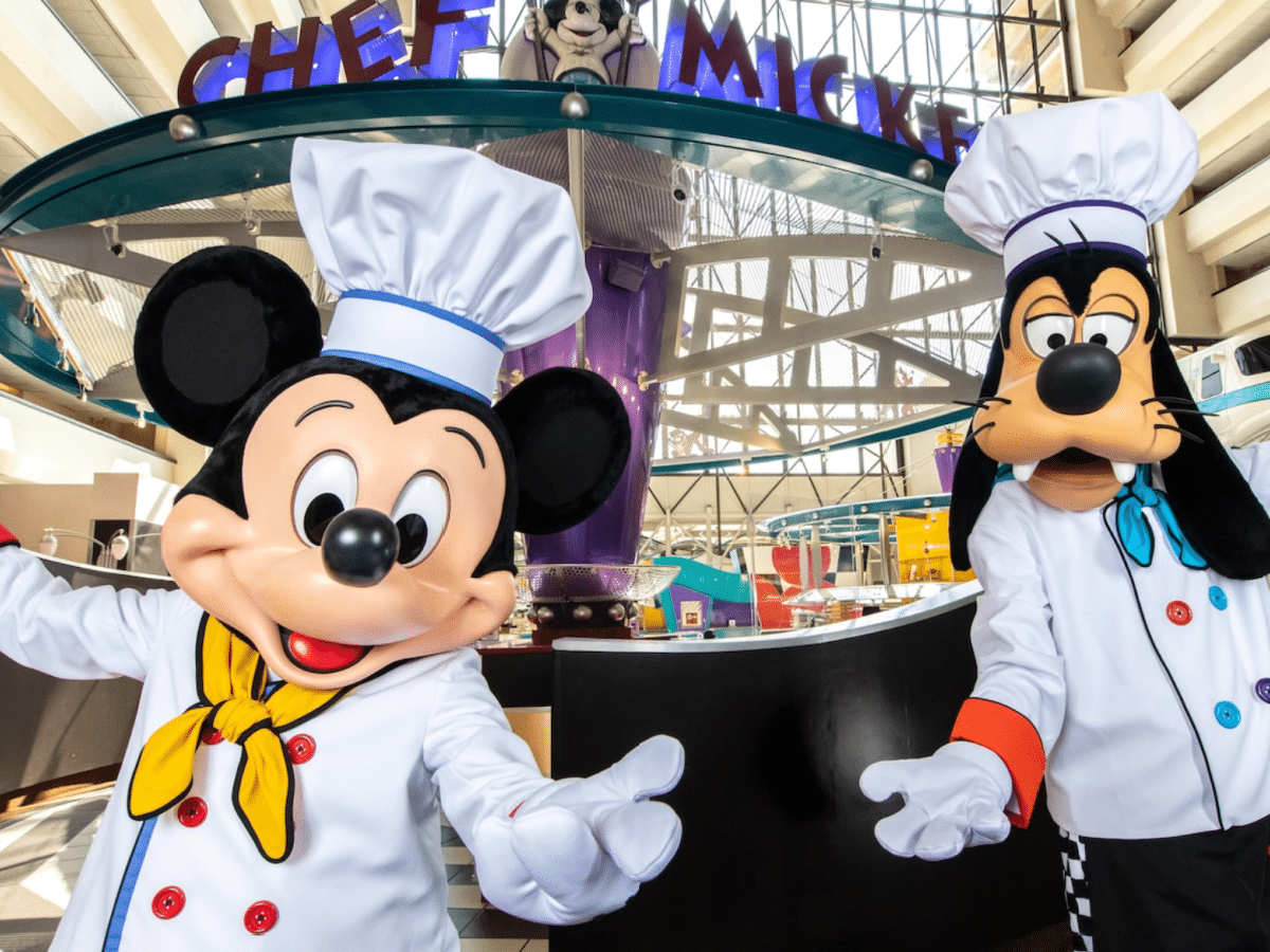 mickey dressed as a chef posed with goofy in a chefs costume