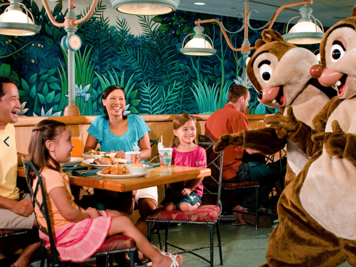 chip and dale making a family laugh while eating at a disney restaurant