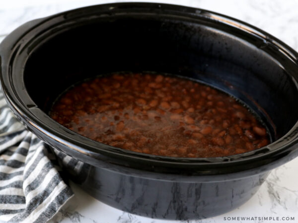 dumping pinto beans into a crockpot
