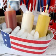 ketchup, mustard, and mayo in a bucket with ice