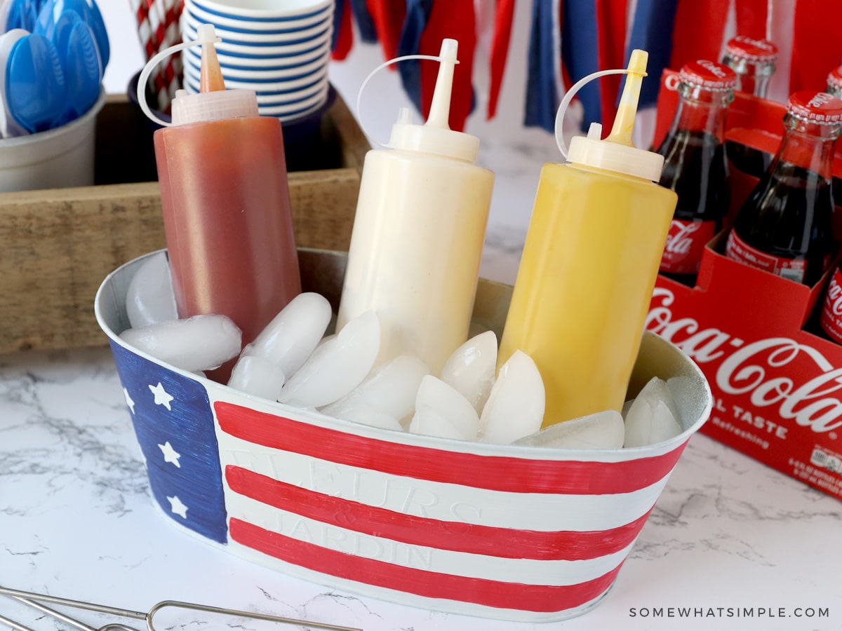 ketchup, mustard, and mayo in a bucket with ice