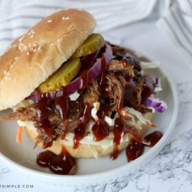 slow cooker bbq beef sandwich on a white plate ready to eat