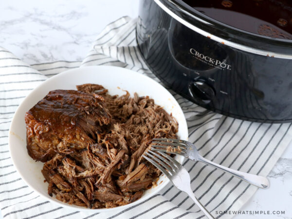 shredding meat with forks