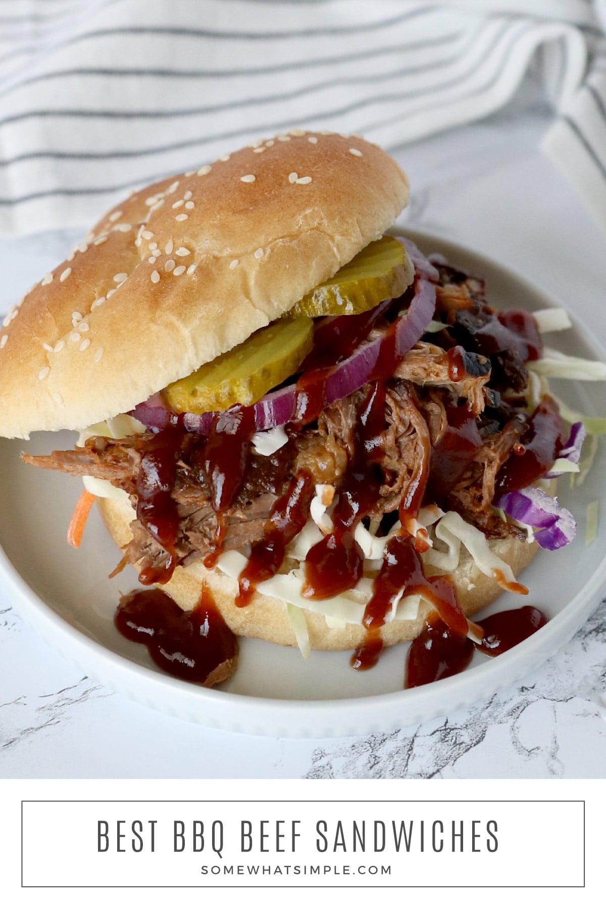 These crockpot BBQ beef sandwiches are made with just 3 ingredients. They're dripping with flavor and so easy to make! via @somewhatsimple