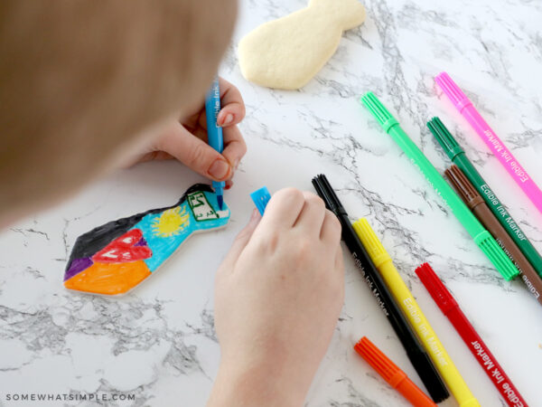 mason decorating a tie cookie for father's day