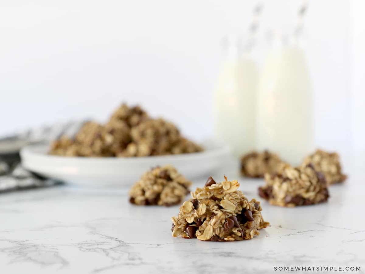 banana oatmeal cookies on a counter with milk in the background