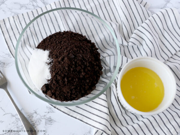 adding butter to crushed oreos