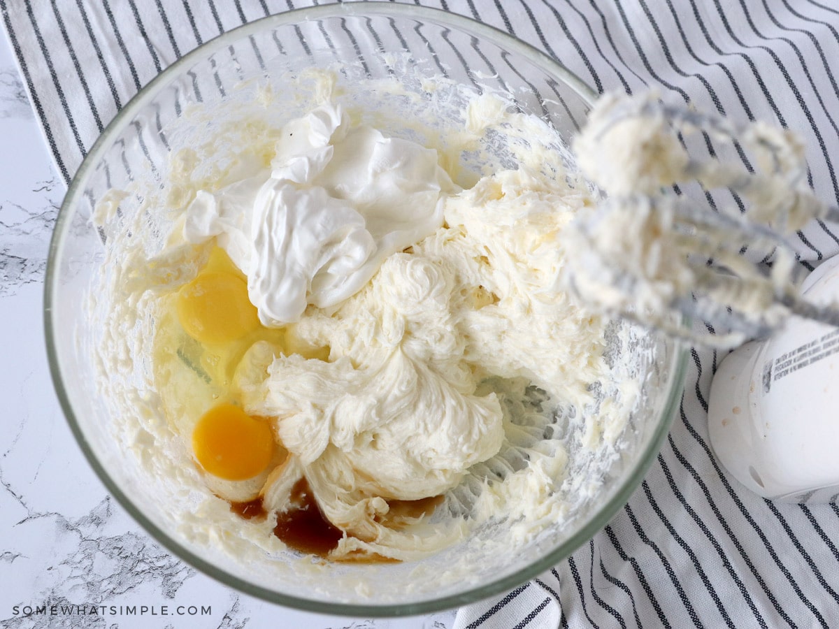 making a cheese cake with all the ingredients in a glass bowl