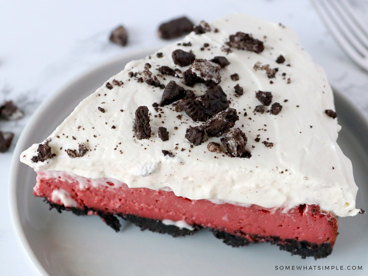 close up of a slice of red velvet oreo cheesecake
