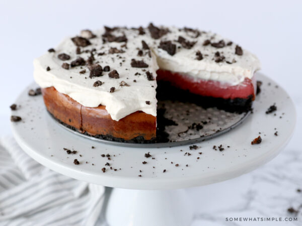red velvet oreo cheesecake with a slice cut out of it
