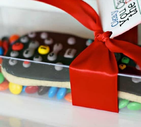 finished cookie for fathers day shaped like a remote control for a TV wrapped in a clear plastic box