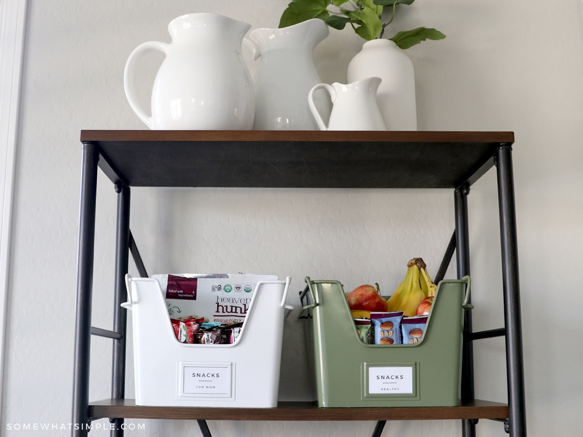 2 cute bins on a shelf full of snacks