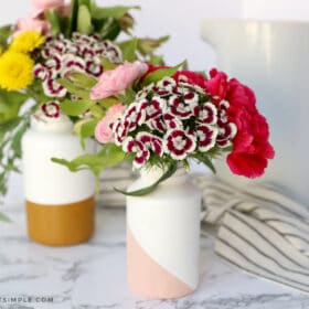 painted flower vases with flowers inside