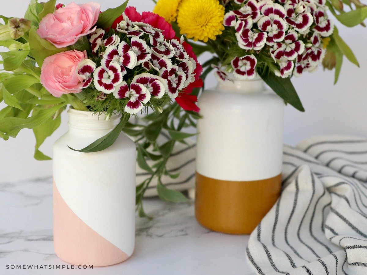 2 recycled medicine bottle made into flower vases