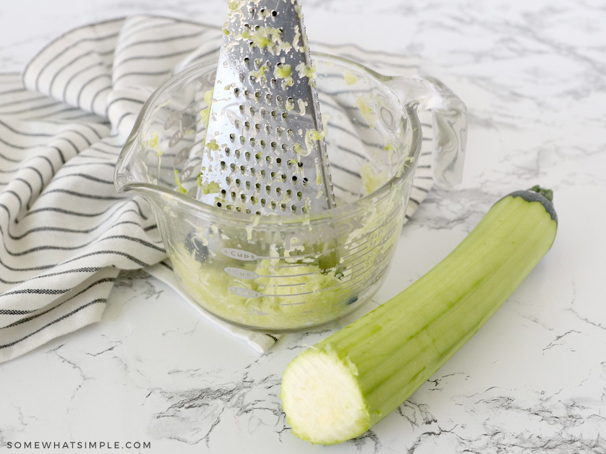 peeling a zucchini then grating