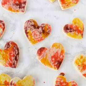 painting sugar cookies with an egg mixture