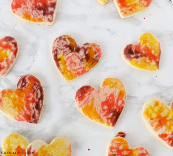 painting sugar cookies with an egg mixture
