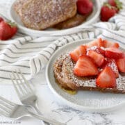 plated zucchini bread french toast with strawberries and whipped cream