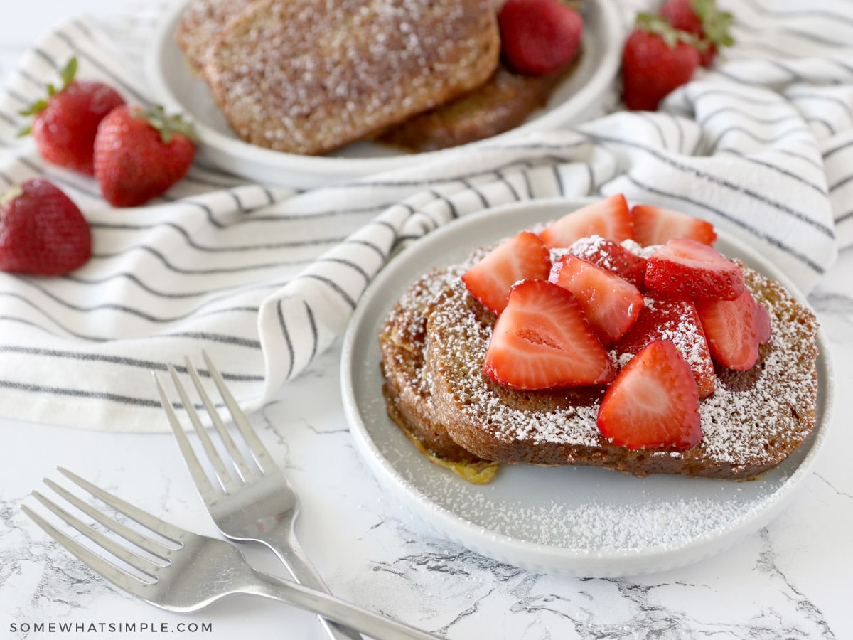 plated zucchini bread french toast with strawberries and whipped cream