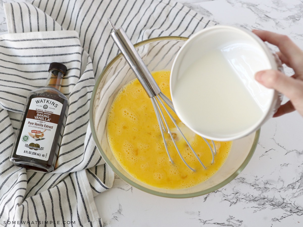 mixing milk and eggs in a large bowl